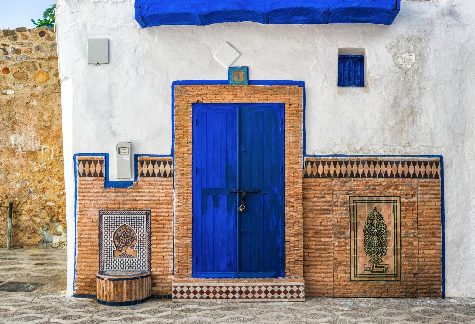 Blue and white painted building with a blue door in the medina of Asilah, Morocco