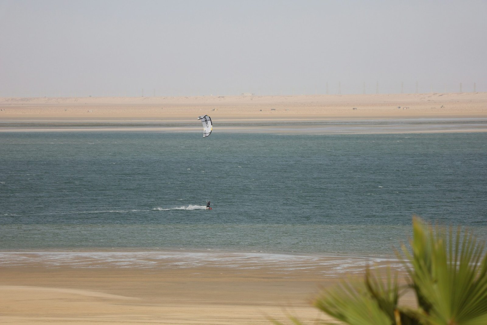 Windsurfer riding the waves in the sunny Dakhla lagoon, Morocco