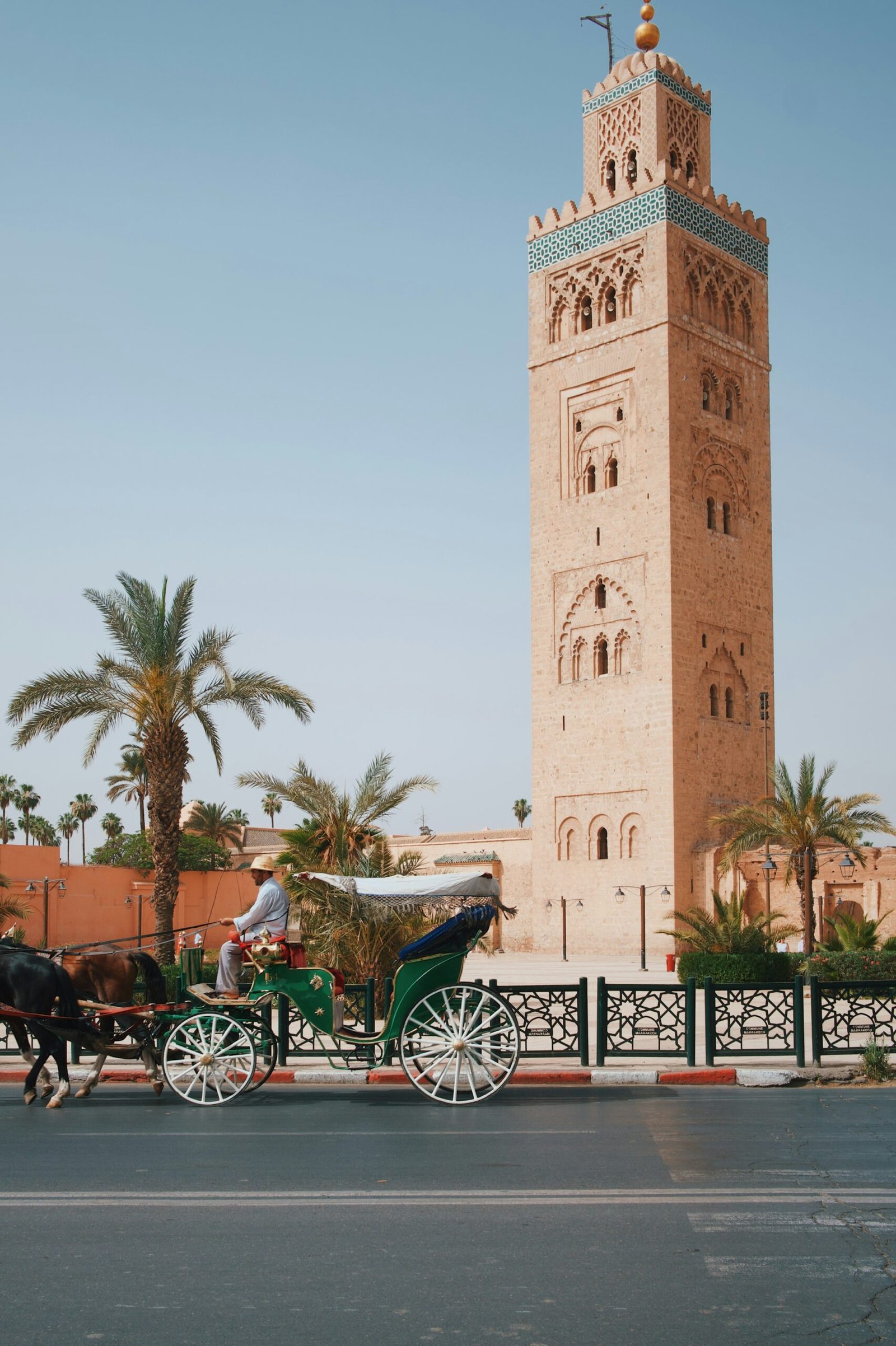 Horse-drawn carriage in front of the Koutoubia Mosque minaret in Marrakech, Morocco