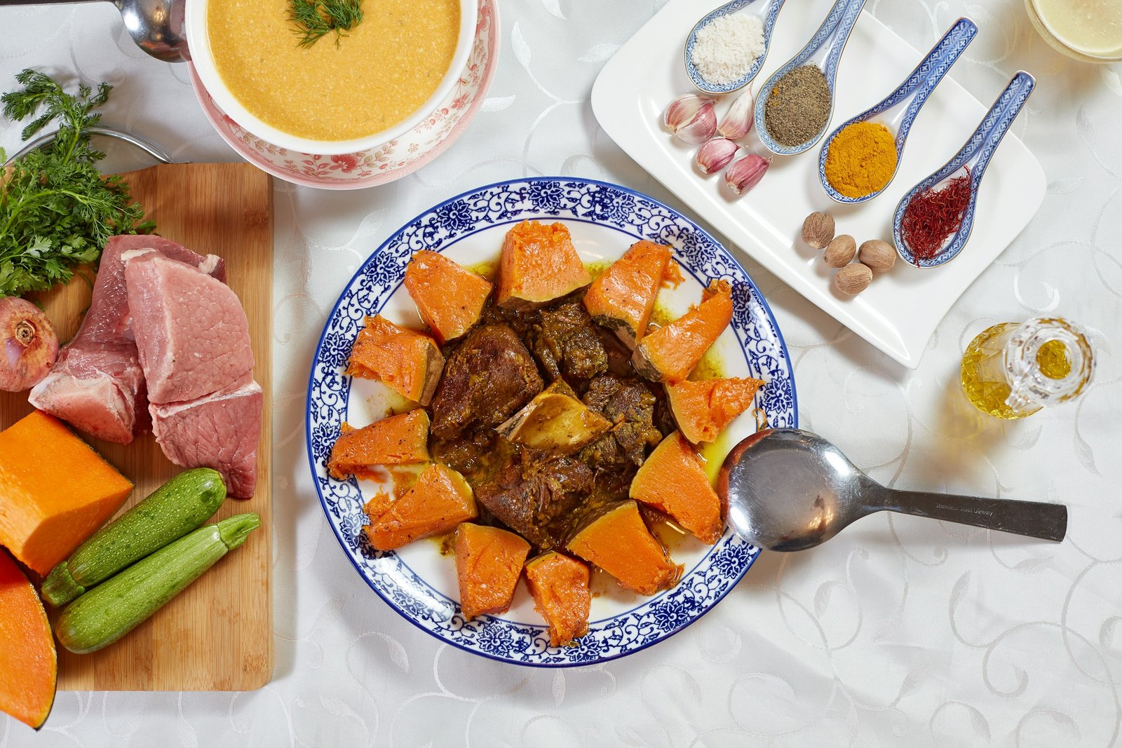 A traditional Moroccan tagine with meat, pumpkin, and spices