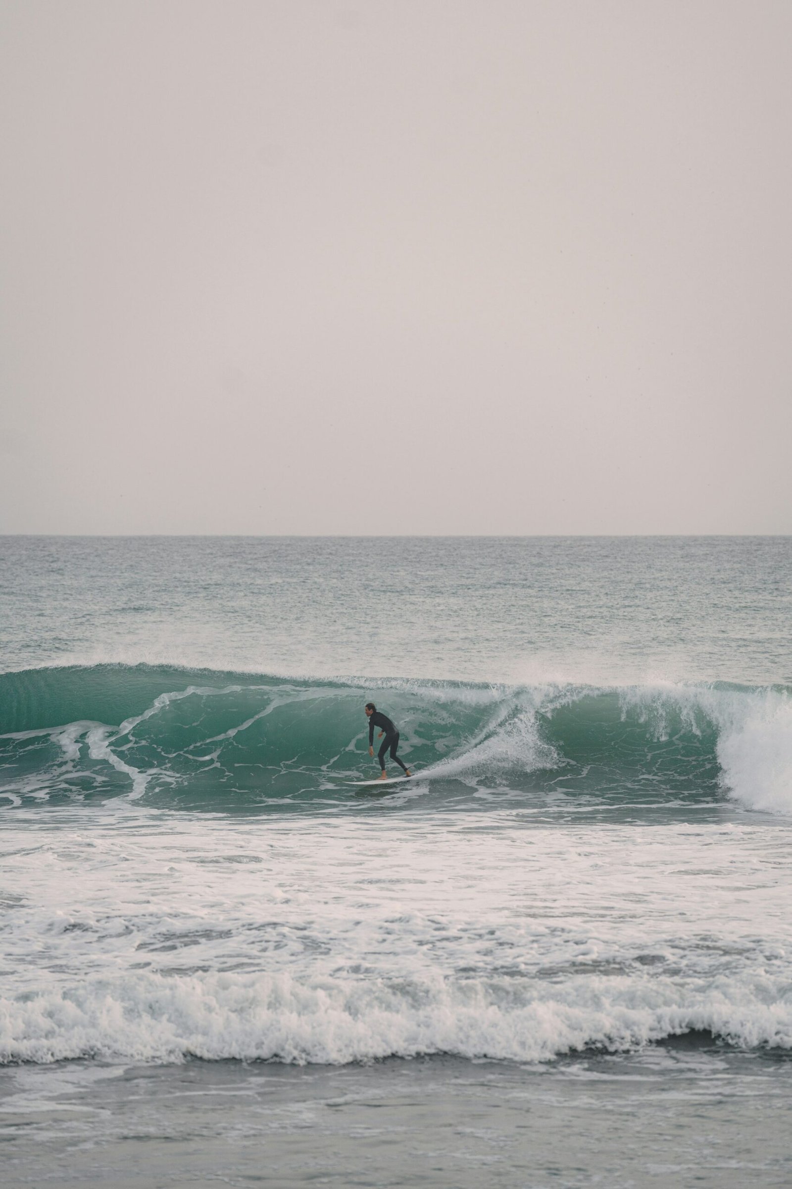 Surfer riding a wave at Anchor Point, Taghazout, Morocco