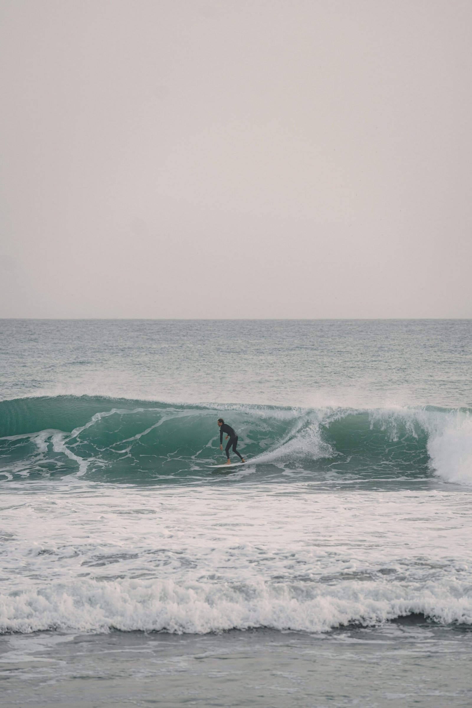 Surfer riding a wave at Anchor Point, Taghazout, Morocco