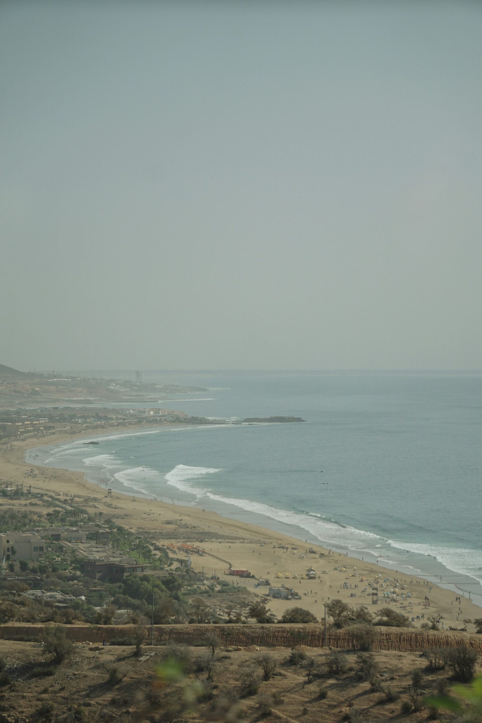 Scenic coastal view of Taghazout beach and ocean from a hilltop, Morocco surf town
