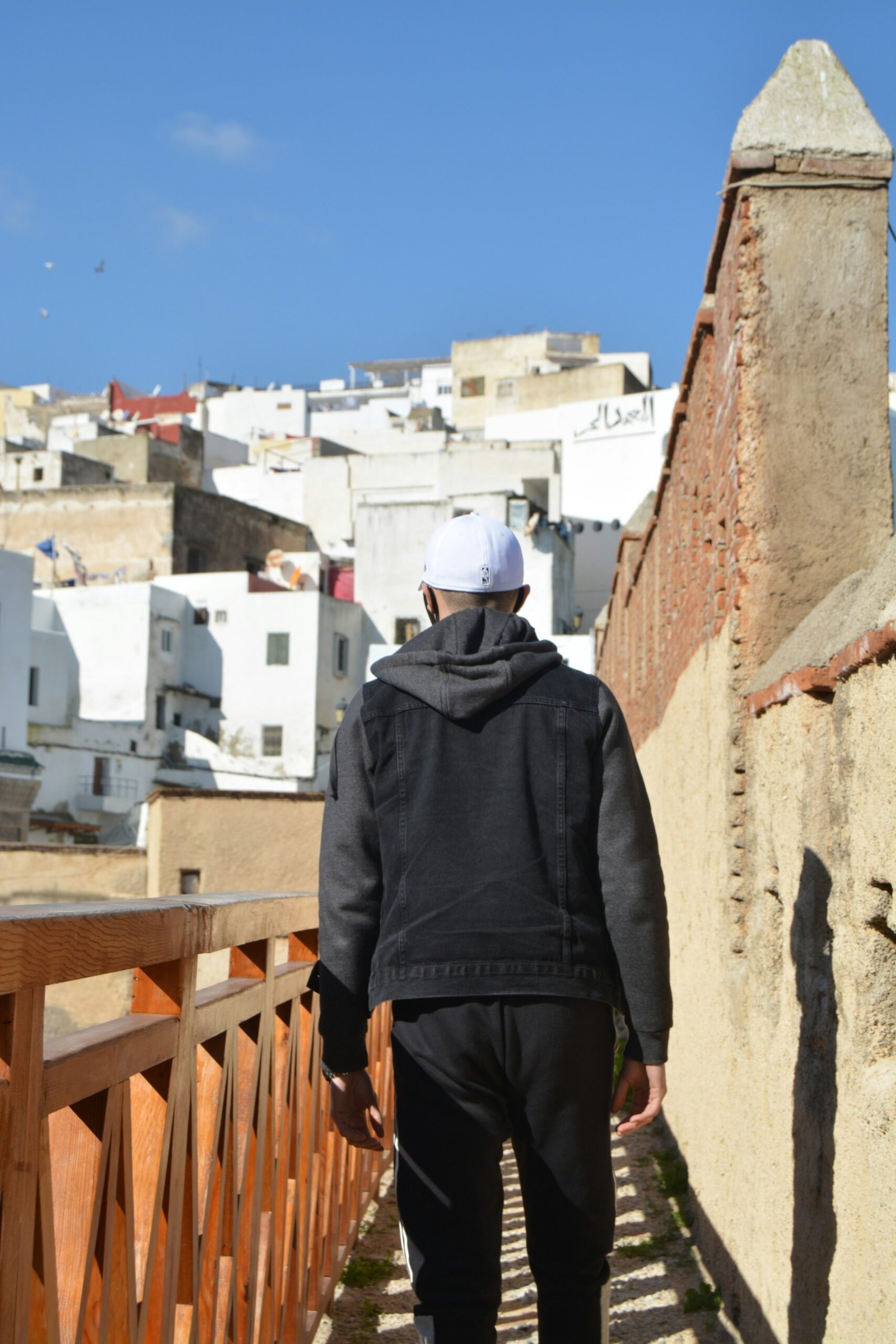 A man walking through a narrow alleyway in the old medina of Tetouan, Morocco