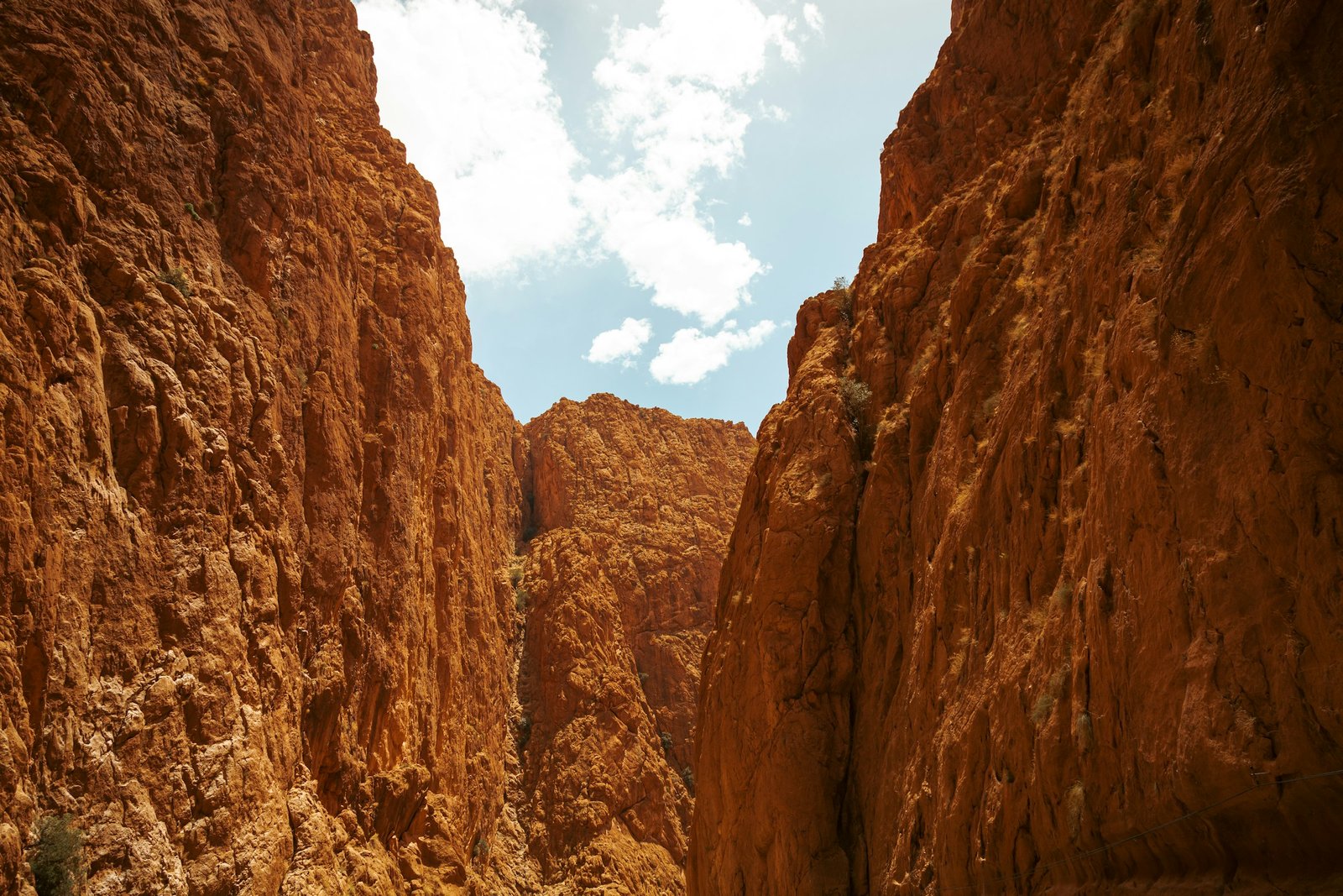 Sheer rock canyon walls under a blue sky at Todgha Gorge near Tinghir, Morocco